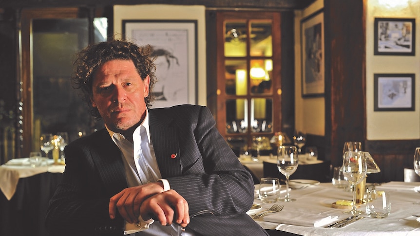 Marco Pierre White sitting at a table in a restaurant