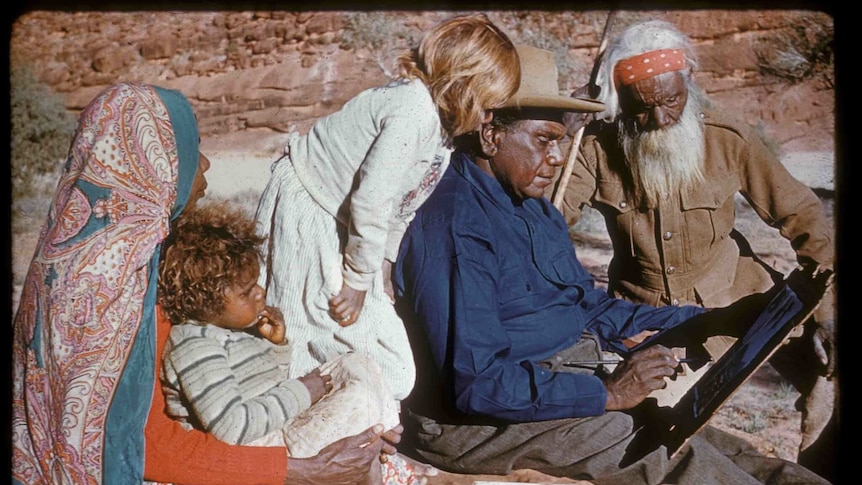 Albert Namatjira painting in the desert with father Jonathon, wife Rubina and grandchildren.