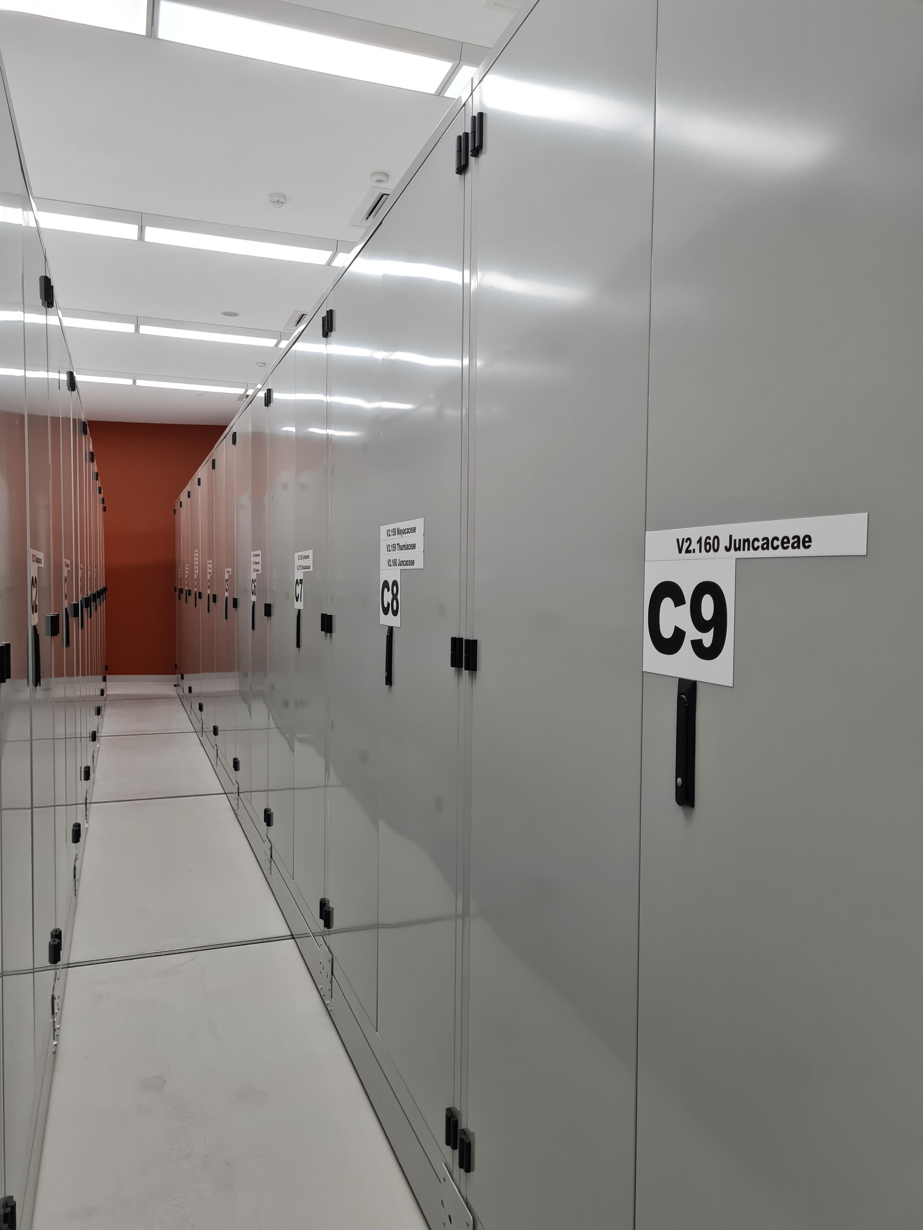 A line of silver vaults with handles and numbers.