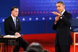 Mitt Romney listens as Barack Obama speaks during the second presidential debate.