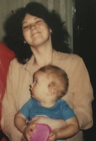 Sharron Phillips, holding her younger brother Matthew, date unknown
