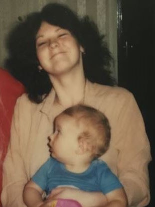 Sharron Phillips, holding her younger brother Matthew, date unknown