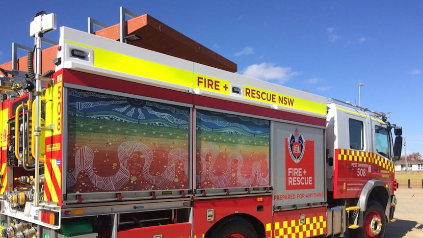 A fire truck with indigenous artwork on the side
