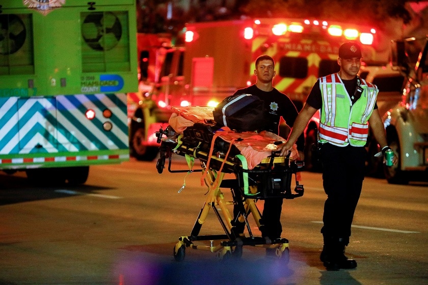 Emergency personnel work at the scene of a partial building collapse in Miami Beach, Florida.