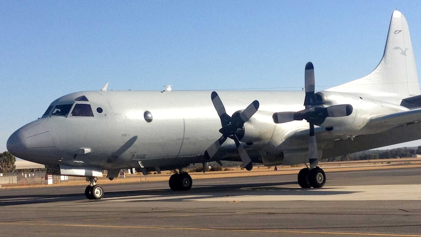 A RAAF aircraft returns after searching in the Indian Ocean