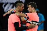 grigor dimitrov and Nick Kyrgios embrace at the net at the end of their fourth-round match at the Australian Open