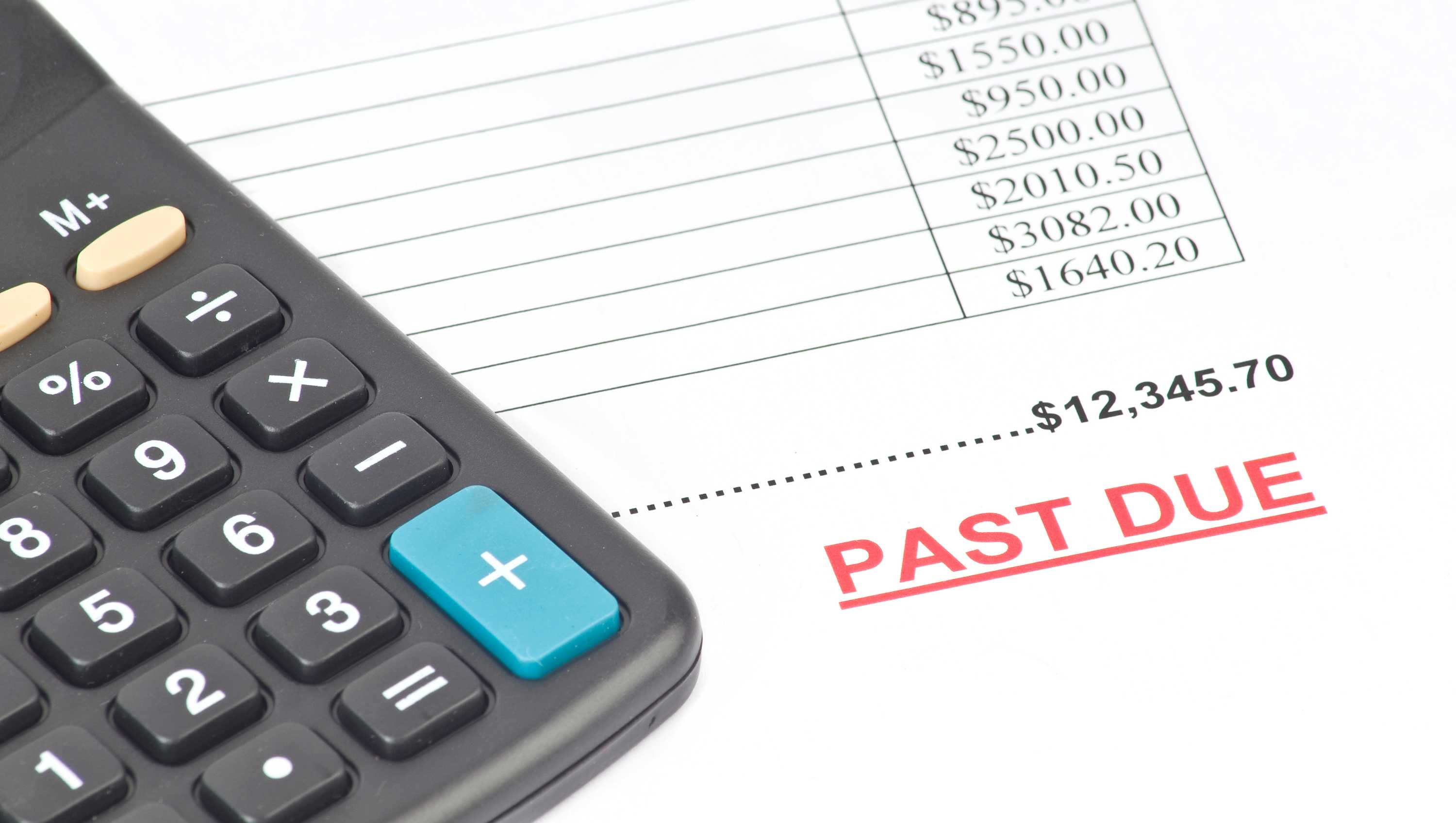 A bill past its due by date and a calculator.