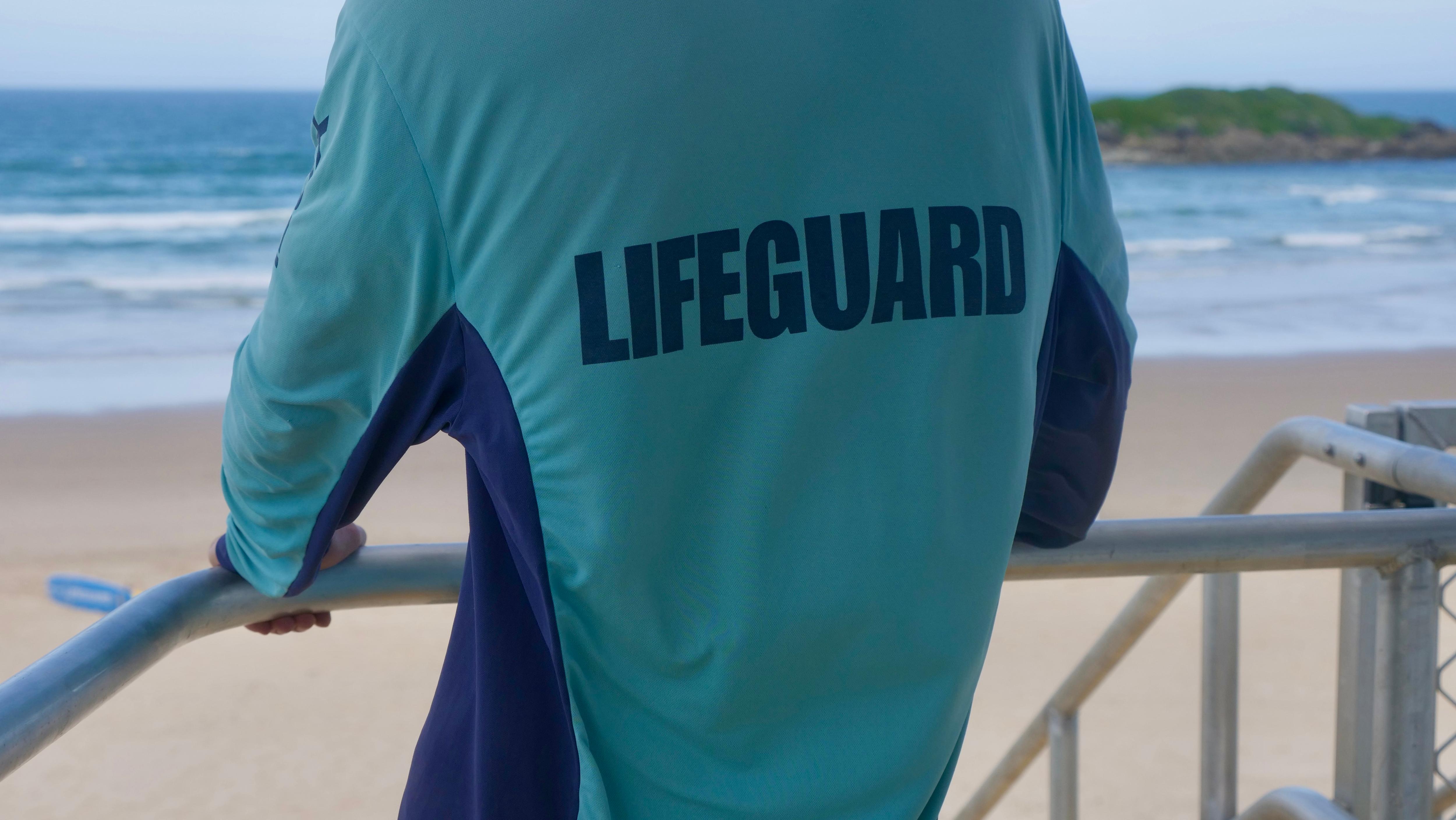 council lifeguard staring at surf from the patrol tower in coffs harbour at park beach