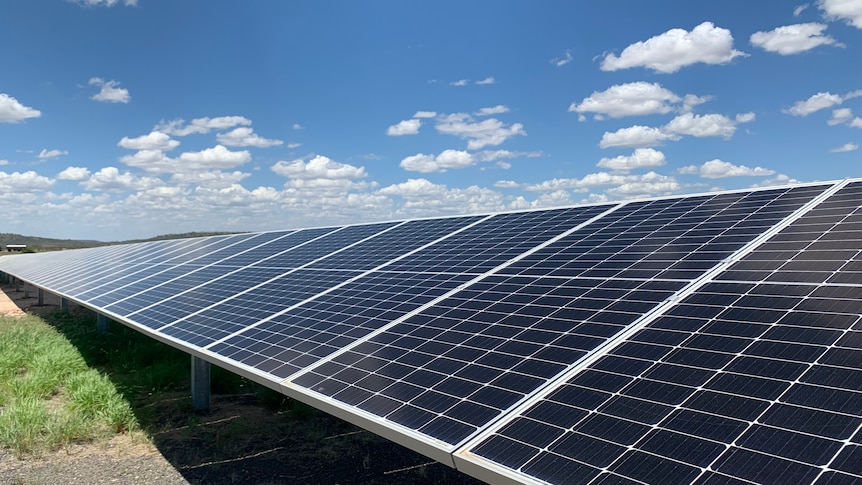 solar panels under partly cloudy sky