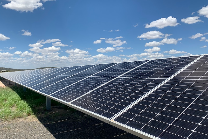 solar panels under partly cloudy sky