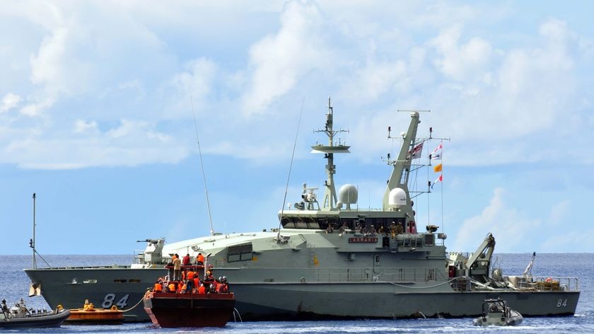 An asylum seekers' boat is escorted to Christmas Island