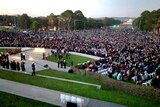 View of the crowd in Canberra on Anzac Day stretching from the war memorial toward parliament house.