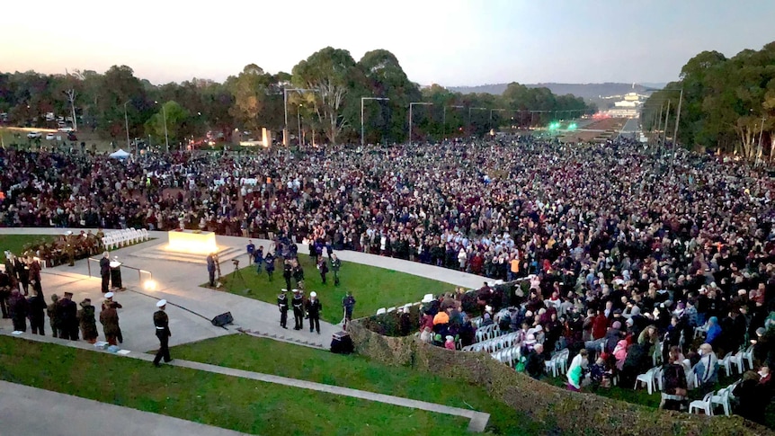 View of the crowd in Canberra on Anzac Day stretching from the war memorial toward parliament house.