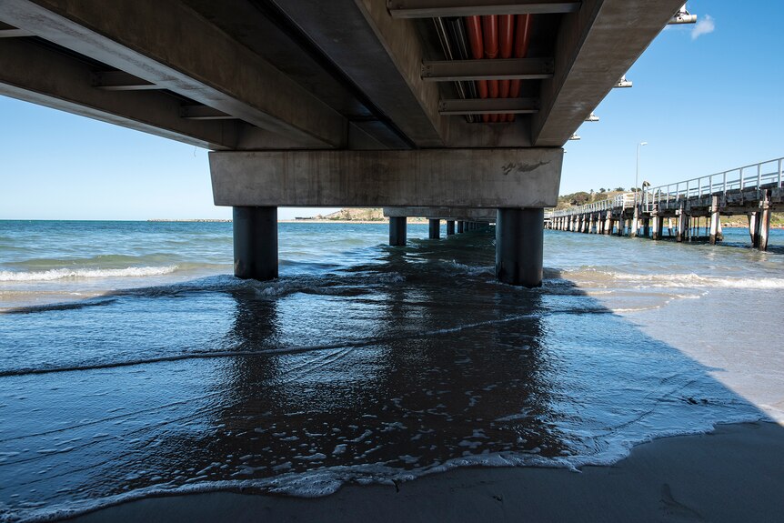 The view beneath a concrete causeway with an older timber causeway alongside