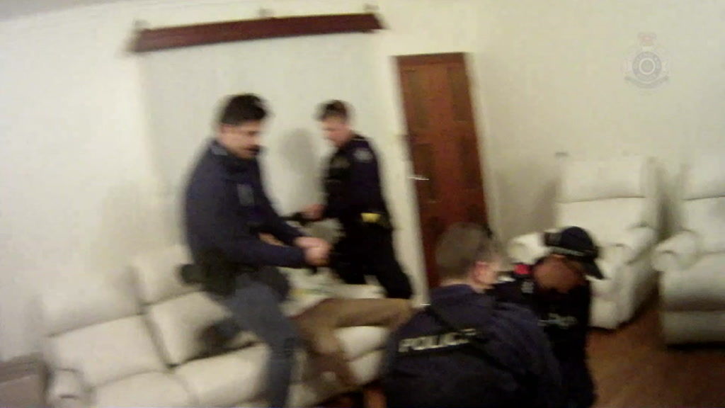 Queensland police arresting a member of the Rebels in a targeted raid ...