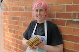 Female baker holding gingerbread biscuits