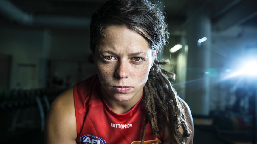 Richelle 'Rocky' Cranston wears a red AFL singlet