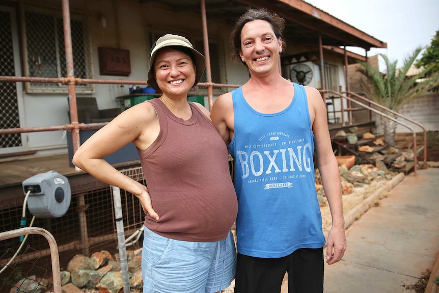 Vicky Irvine and Kynan standing in front of their house.