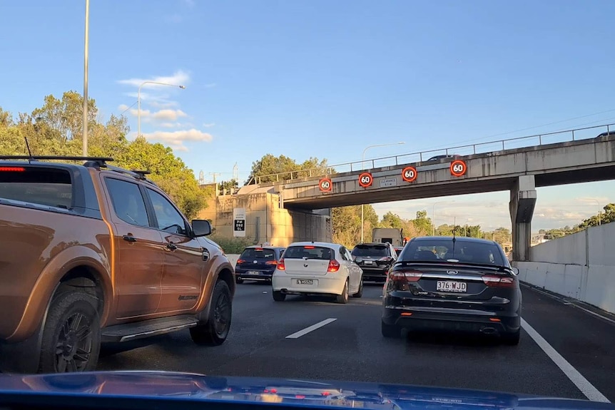 A traffic jam on a motorway as seen through the windscreen of a car on the road