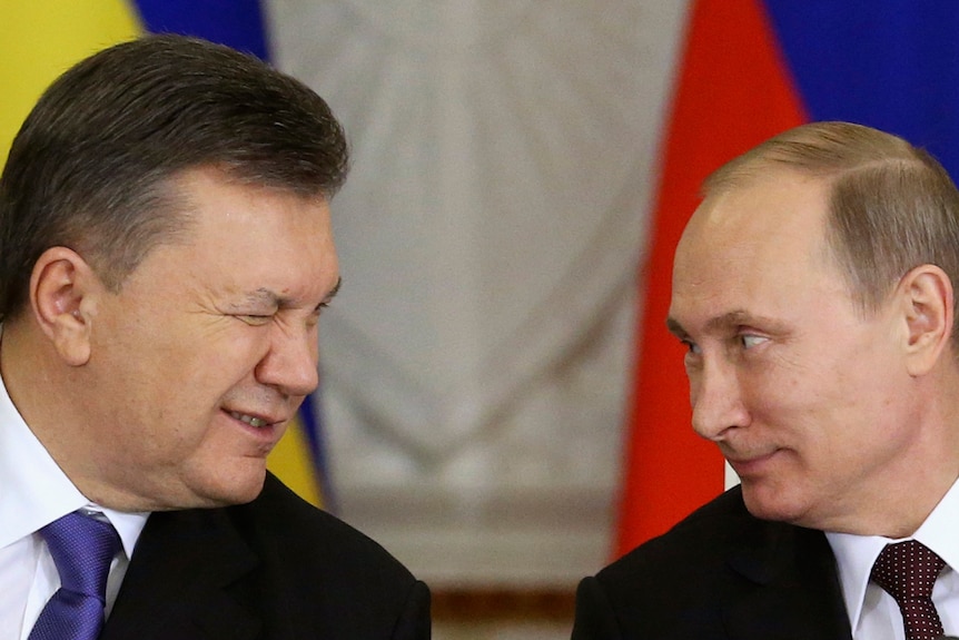 Ukrainian President Viktor Yanukovych gives a wink to his Russian counterpart Vladimir Putin during a signing ceremony