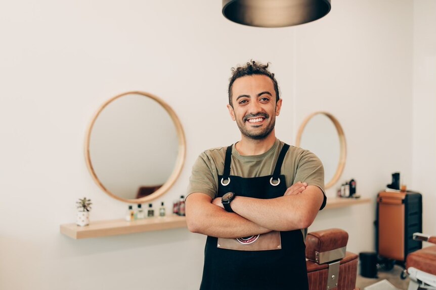 Behnam Nazifi in his barber shop in Melbourne.