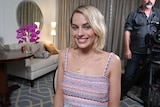 Medium close up of Margot Robbie seated in a hotel room. Interviewed for 7.30, March 2018