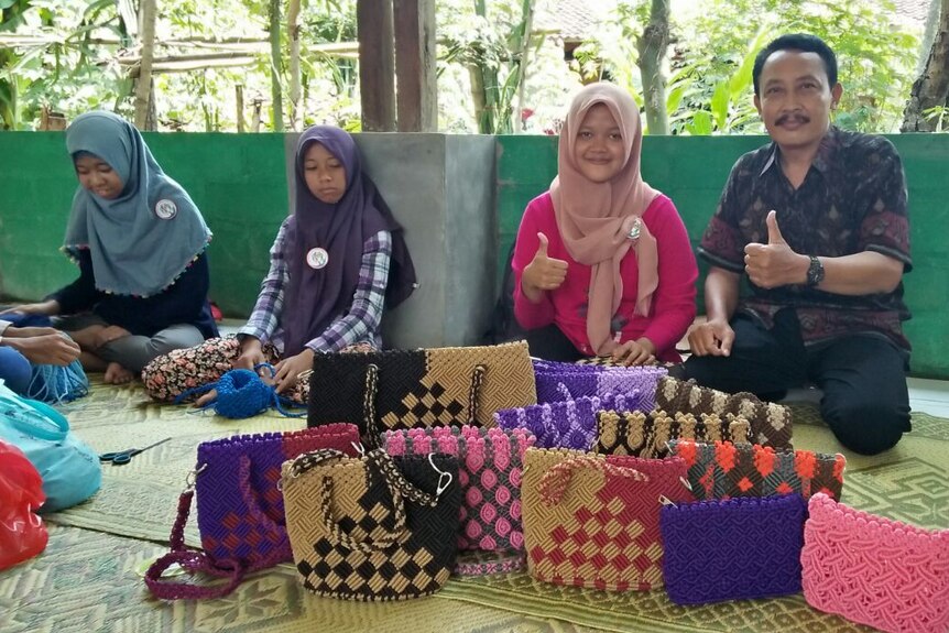 Twpo people  showing bag made by traditional weaving method