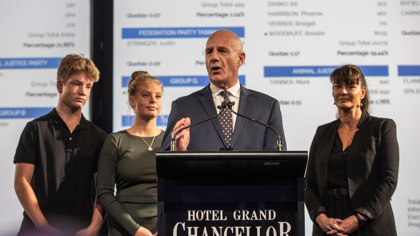 Premier Peter Gutwein on stage with his family on the election night.