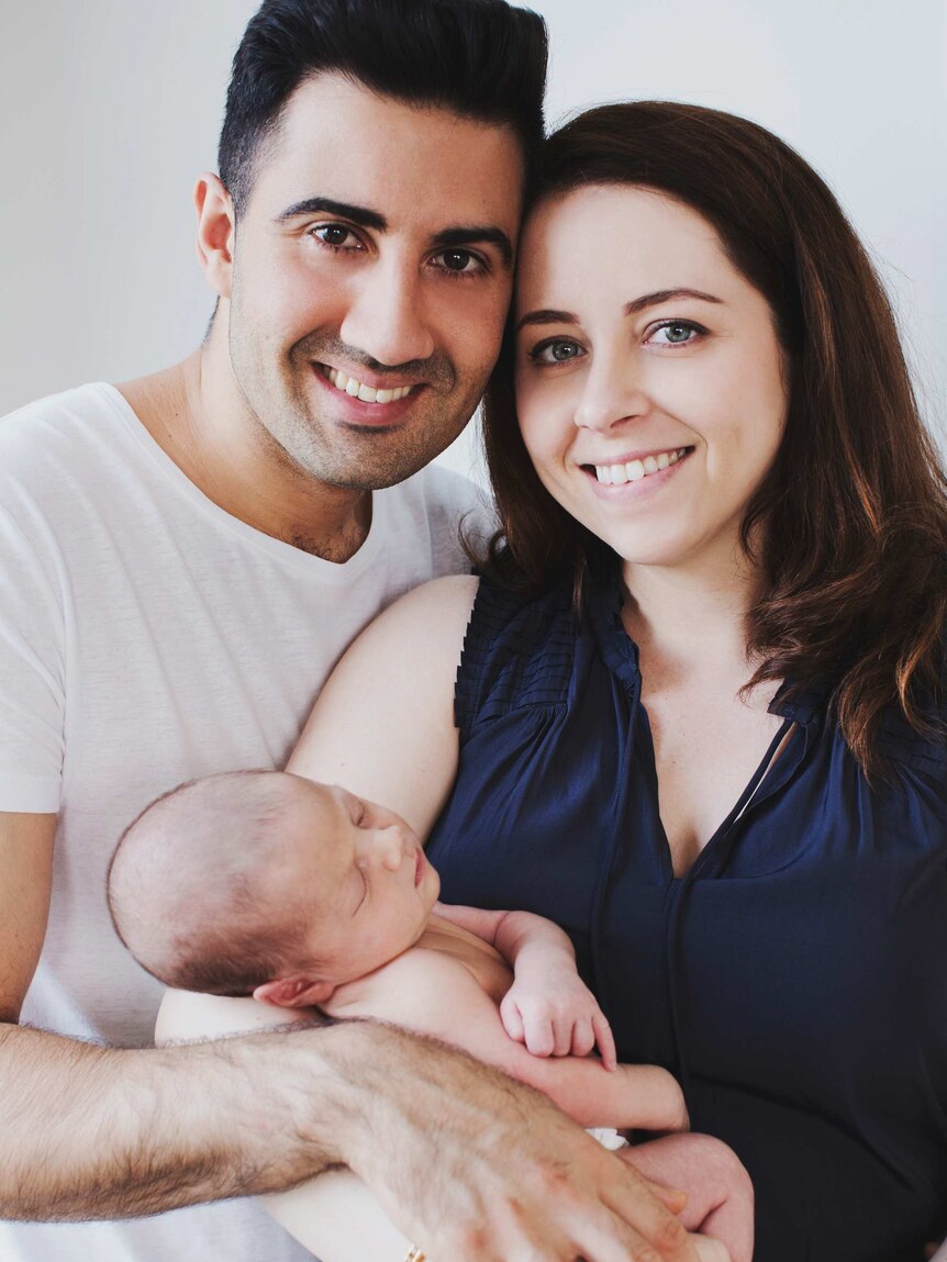 Emilia Rossi stands with her husband while holding her baby, she changed her habits after auditing the way she spent her time.