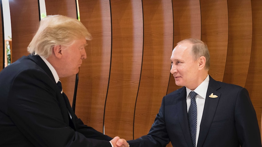 Donald Trump shakes hands with an excited looking putin in the foyer