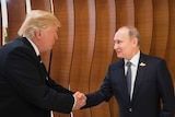 Donald Trump shakes hands with an excited looking putin in the foyer