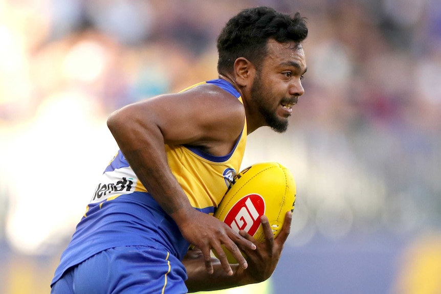 Willie Rioli runs with a football.