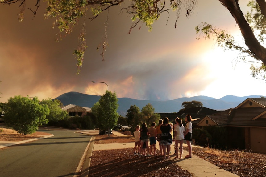 Children in Banks watch the fire burn over the mountain ridge.