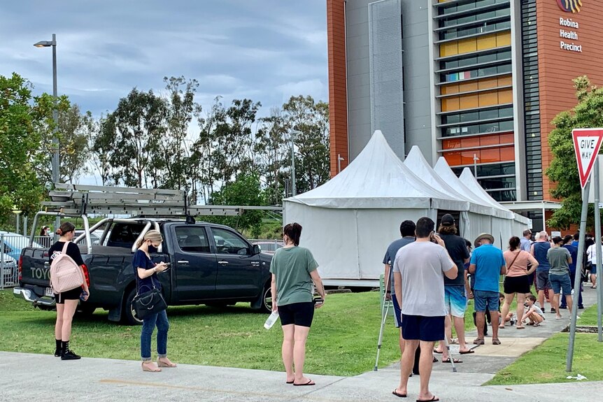 People lining up at a COVID testing tent