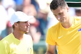 Bernard Tomic speaks to Lleyton Hewitt during the Davis Cup tie against John Isner