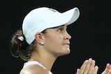 An Australian female tennis player claps her hands on Rod Laver Arena.