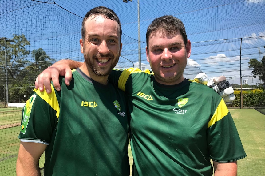 Cricket players Josh Waldhunter and Justin Nilon standing in the cricket nets during practice.