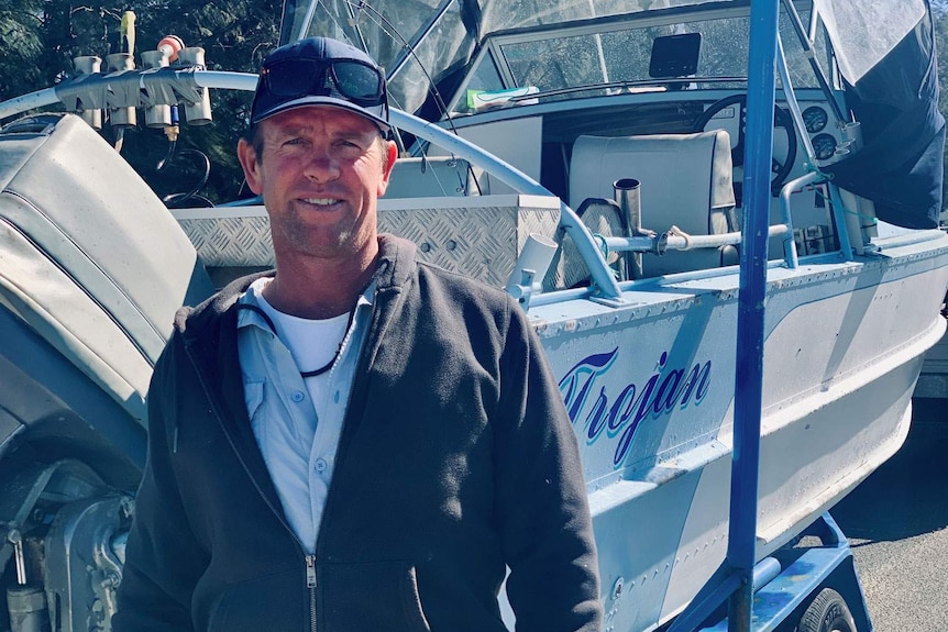 Ben Thomson stands beside his boat at The Spit on Queensland's Gold Coast.