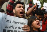 Indian protesters hold placards and shout during a demonstration in New Delhi.
