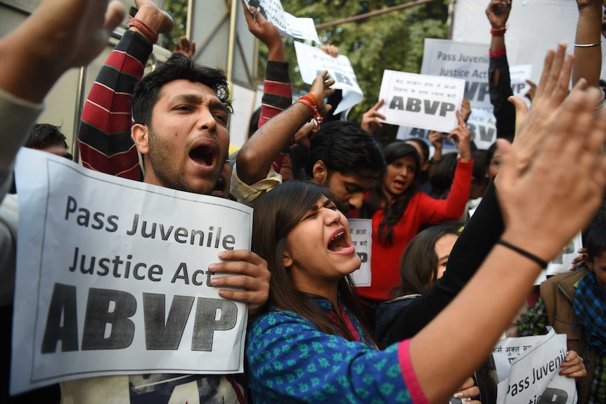 Indian protesters hold placards and shout during a demonstration in New Delhi.