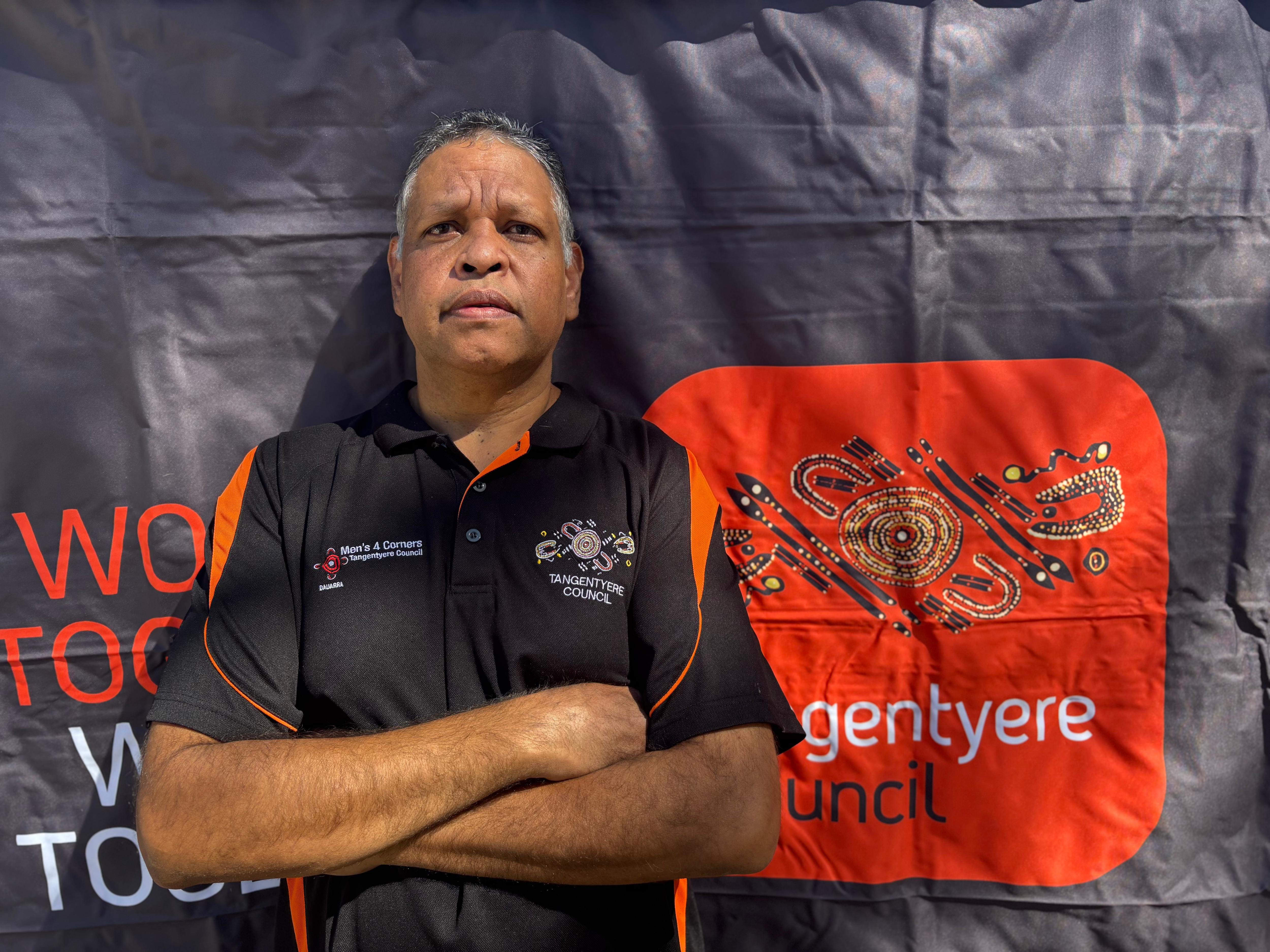 A man stands with his arms crossed