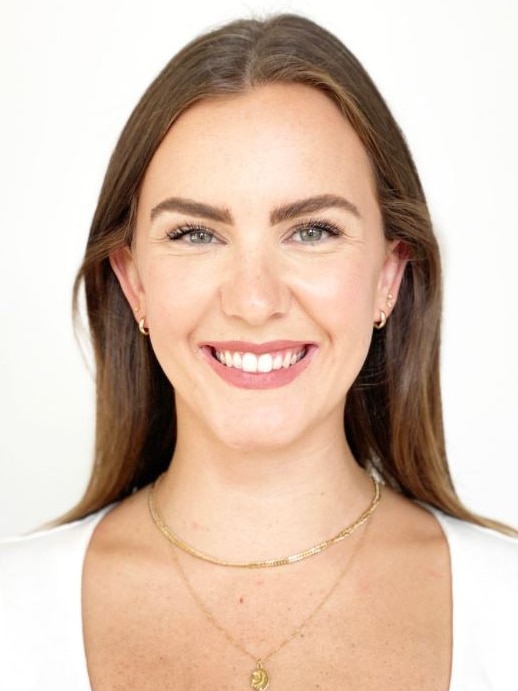 A portrait photo of a woman in her 30s in a white top.