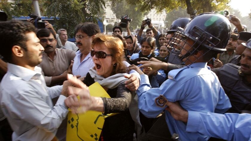 Crackdown: Police attempt to arrest a civil rights activist at an anti-government protest in Islamabad
