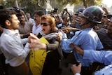 Crackdown: Police attempt to arrest a civil rights activist at an anti-government protest in Islamabad