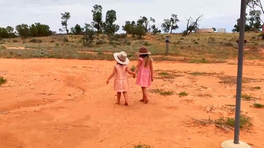 Two girls walking hand in hand