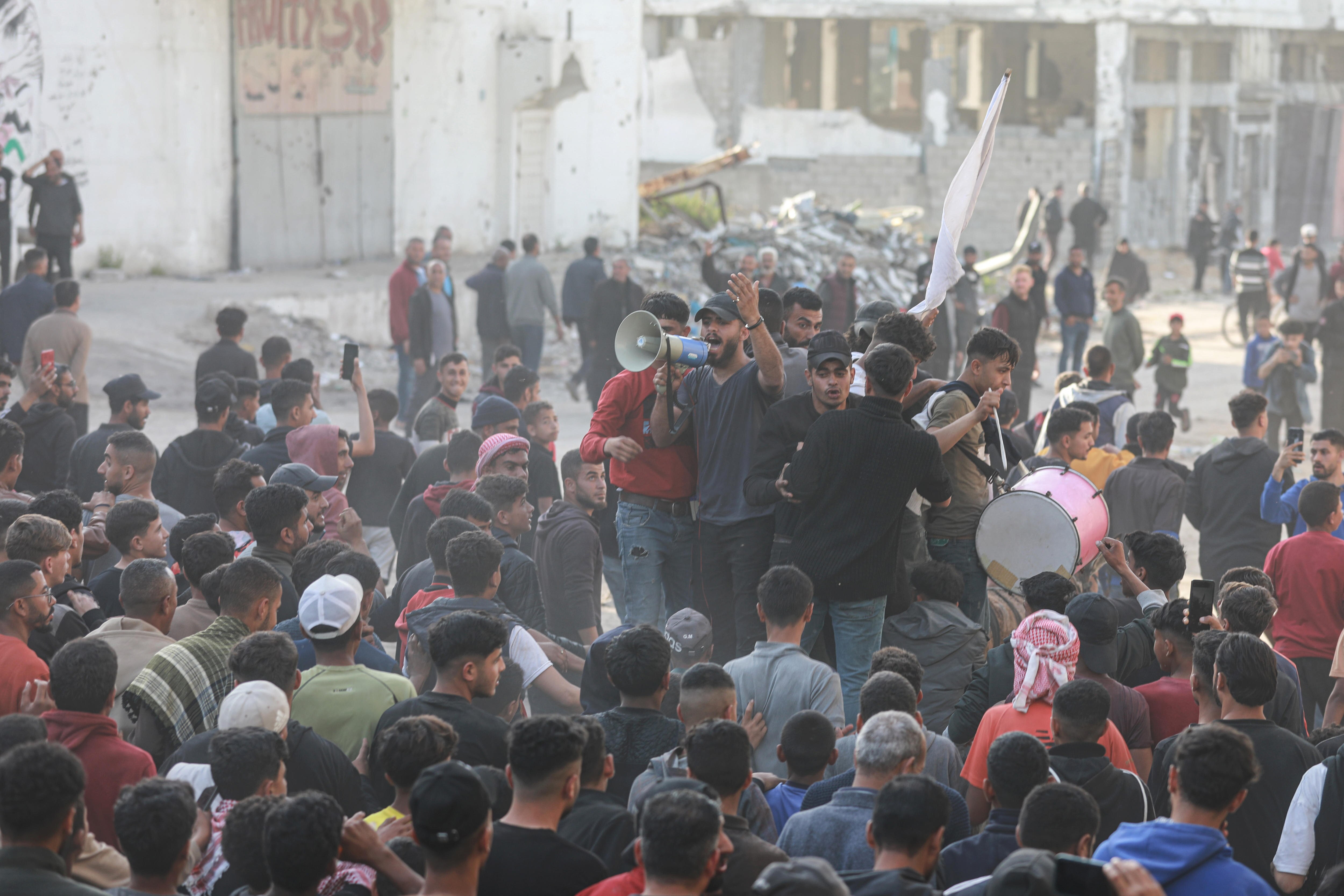 Dozens of people can be seen at a protest on the streets of Gaza.