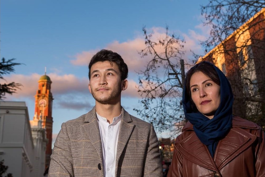 Yousef, left and Fatemeh, right, look off to the left hand side, with Launceston in the background.