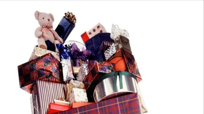 Woman carrying a towering pile of gifts