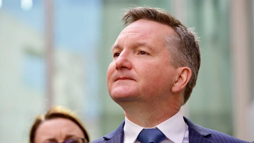 Chris Bowen holding his chin up as he waits for a question at a press conference