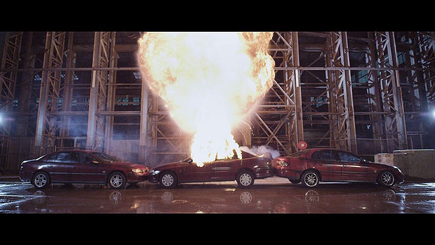 Three Holden Commodores being destroyed